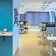 A photograph of Parachut's office with a 3D logo on a wall and working office desks.