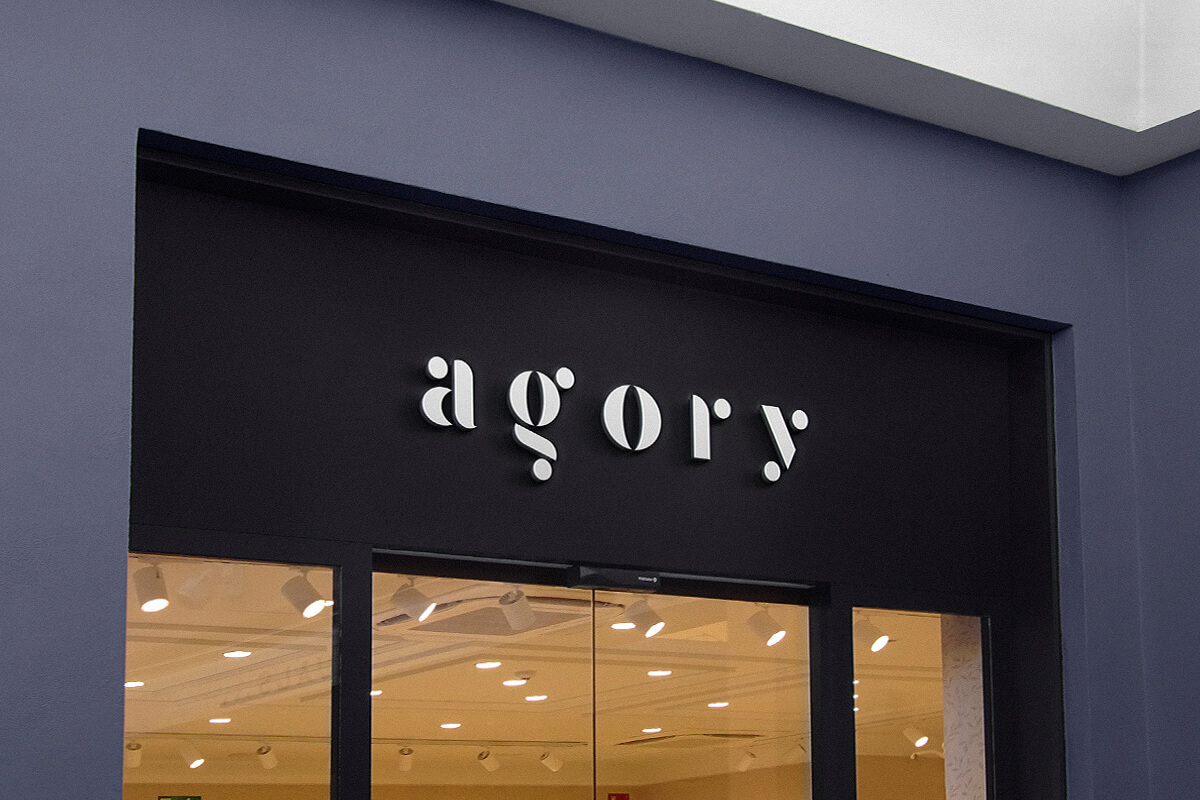 The outdoor illuminated 3D logo above a shop's entrance.