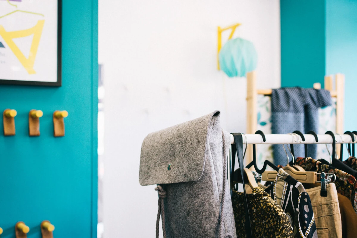 Photograph of the MODETEKA store interior including custom made lighting and cloths hangers.