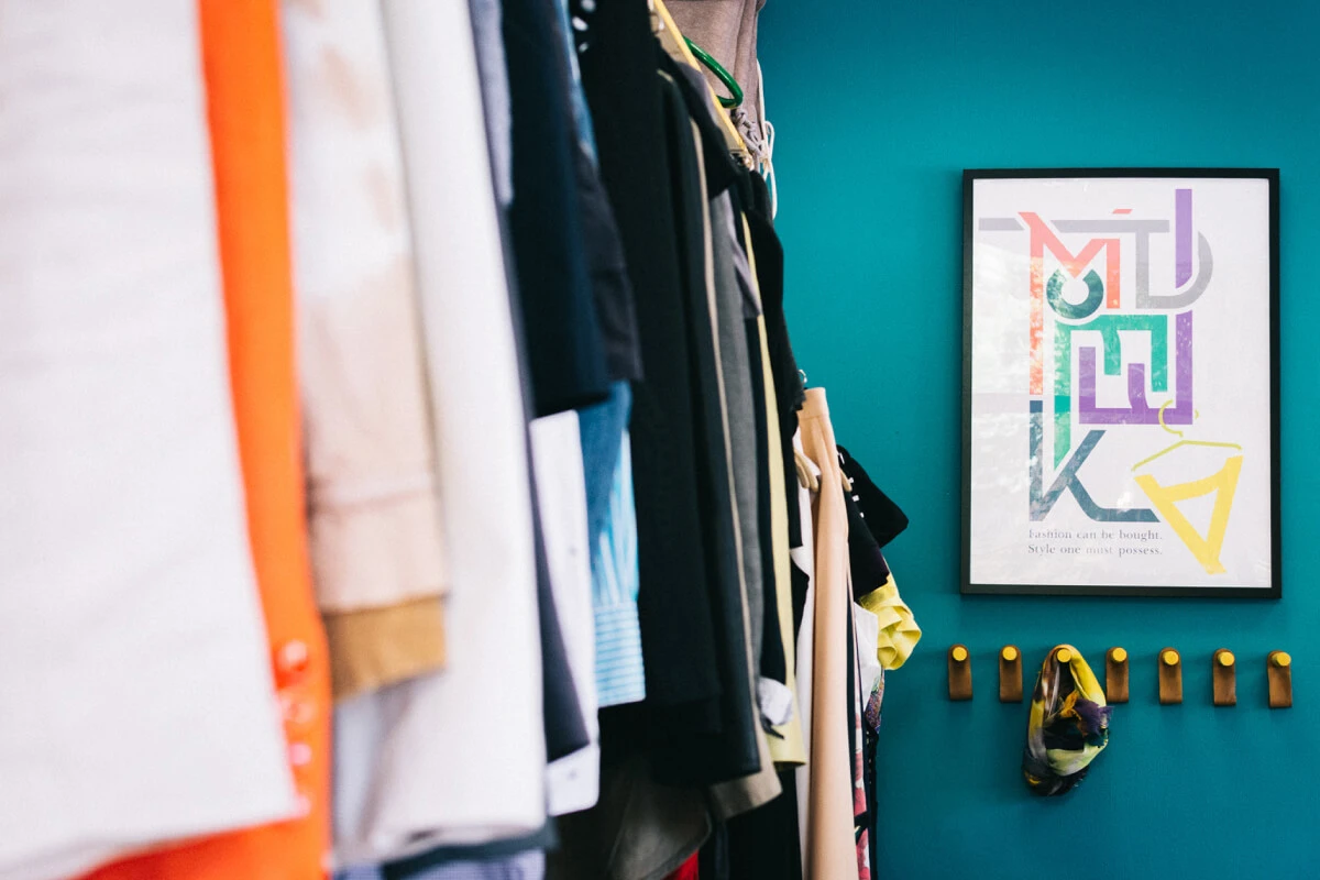 Photograph of the MODETEKA store interior including custom art and scarf hangers.
