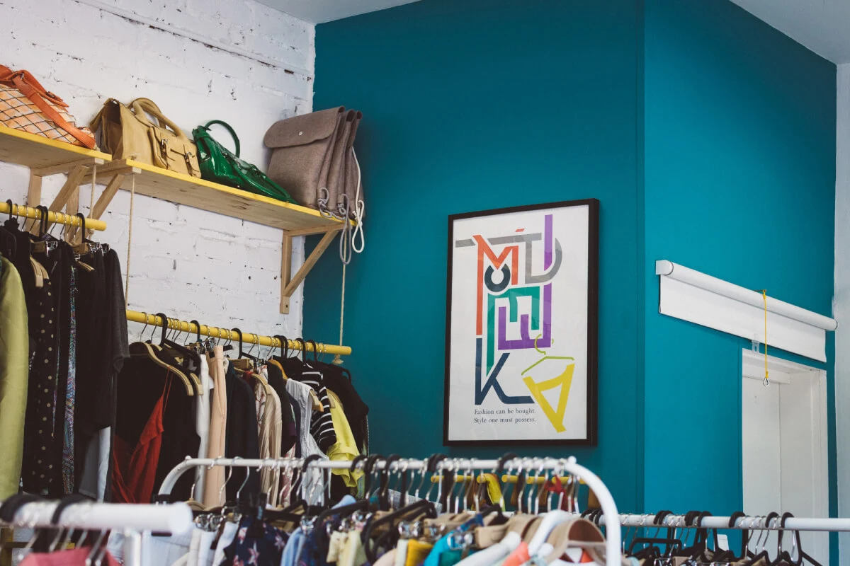 Photograph of the MODETEKA store interior, including custom racks and art.