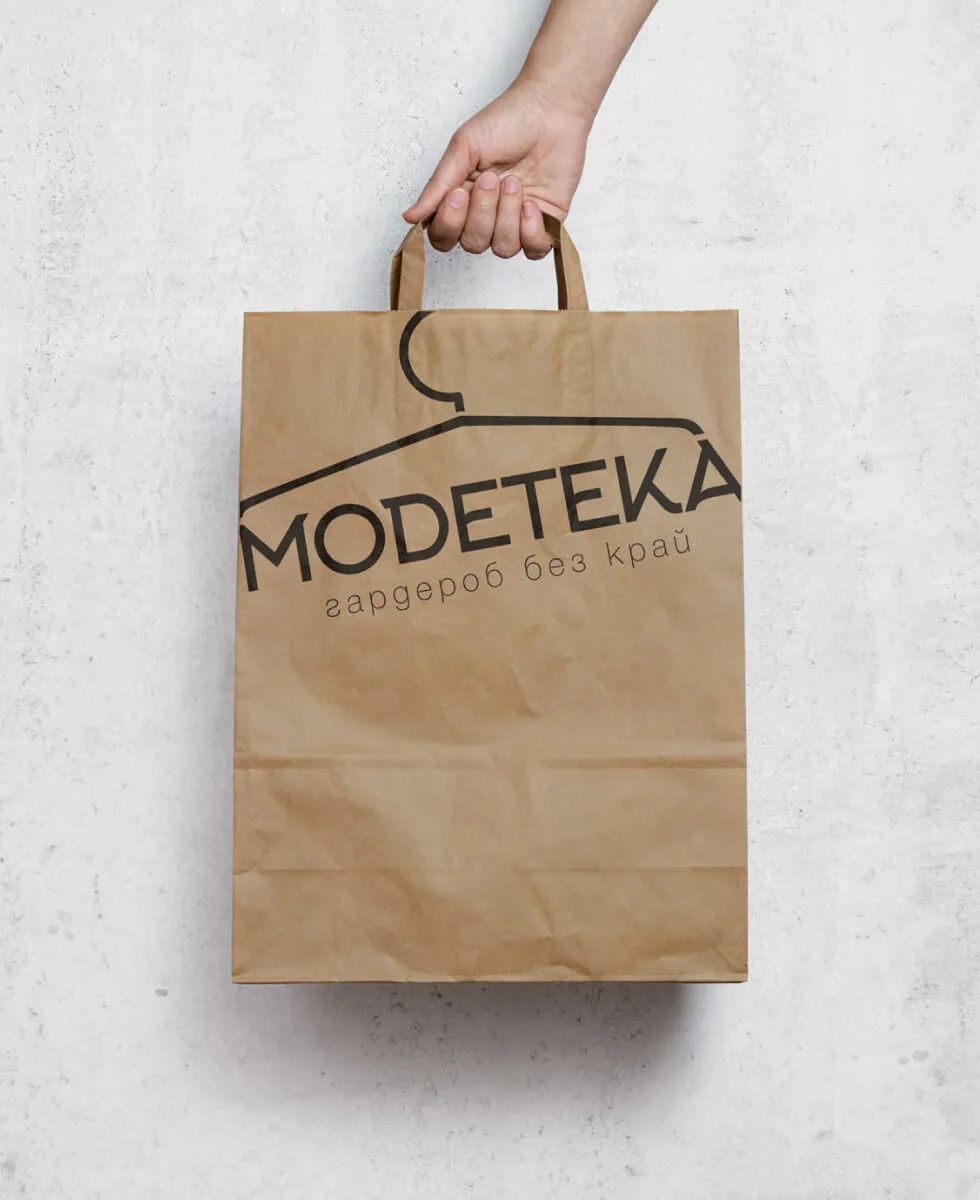 An original design of a paper bag with MODETEKA's branding.