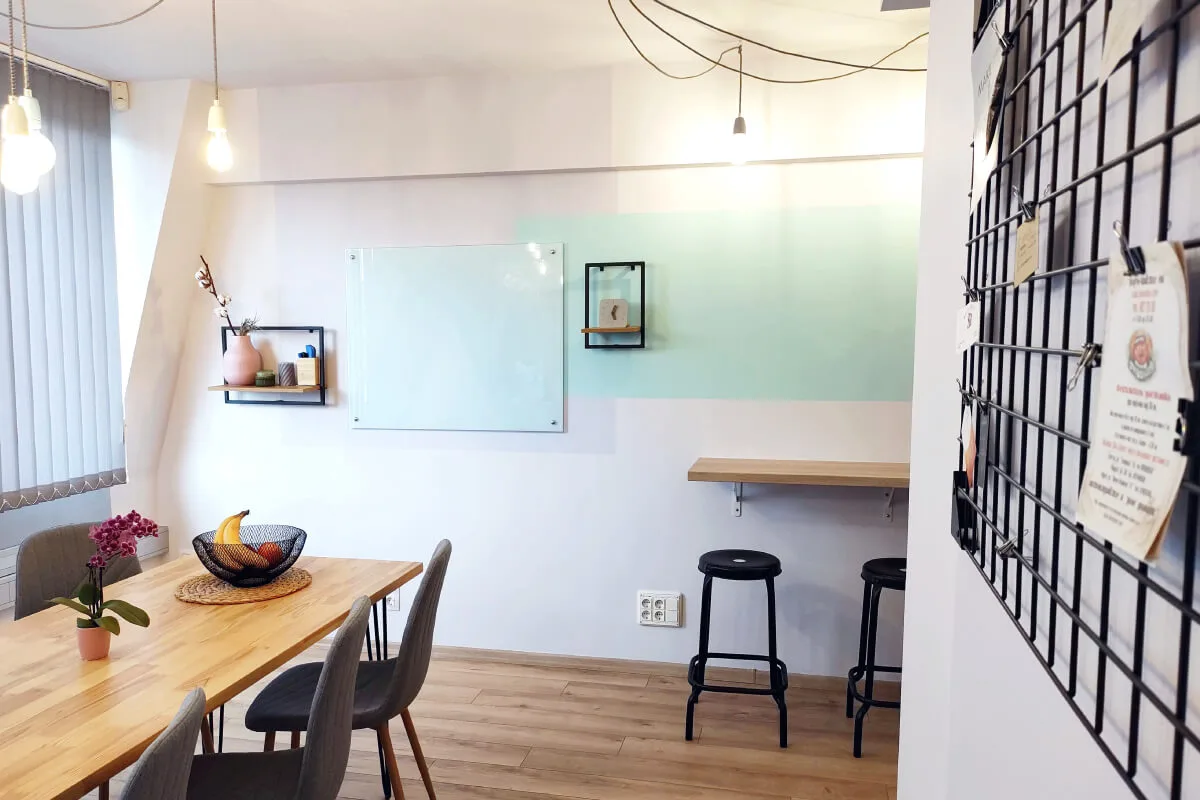 A photograph of the kitchen decoration and custom-made dinning table and bar at Parachut's office.