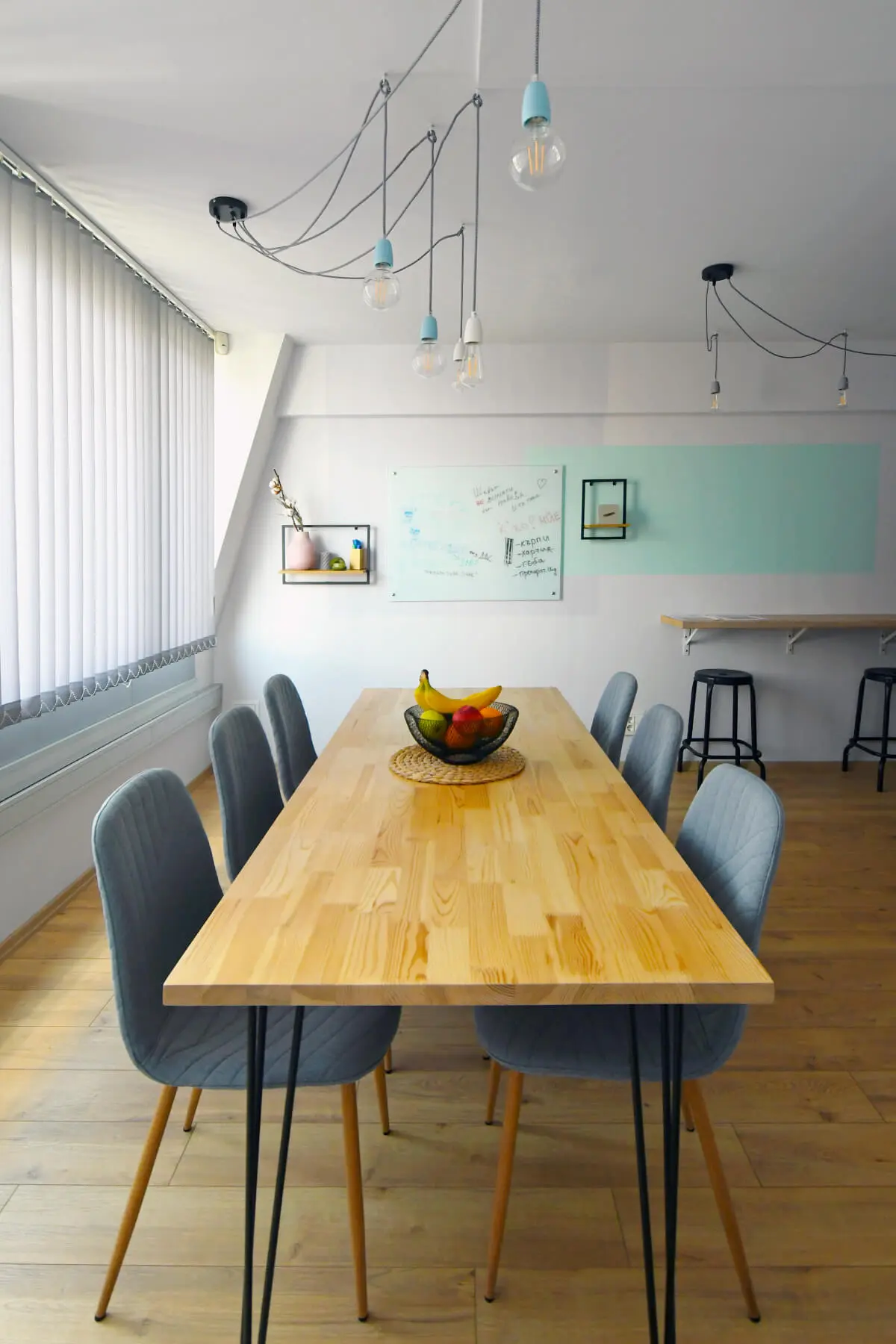 The custom-made table, decor, and lighting at the Parachut's office kitchen.