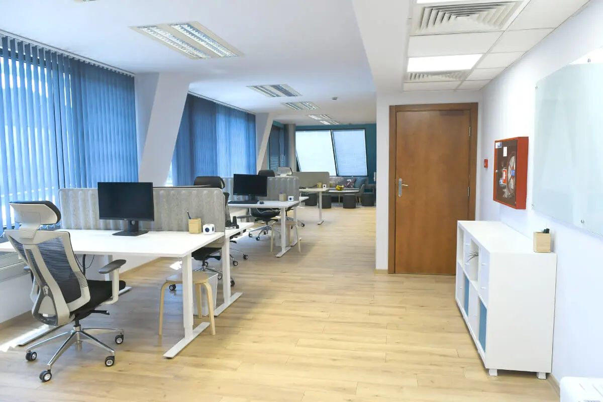 A photograph of Parachut's office with a custom-branded whiteboard on a wall and working office desks.