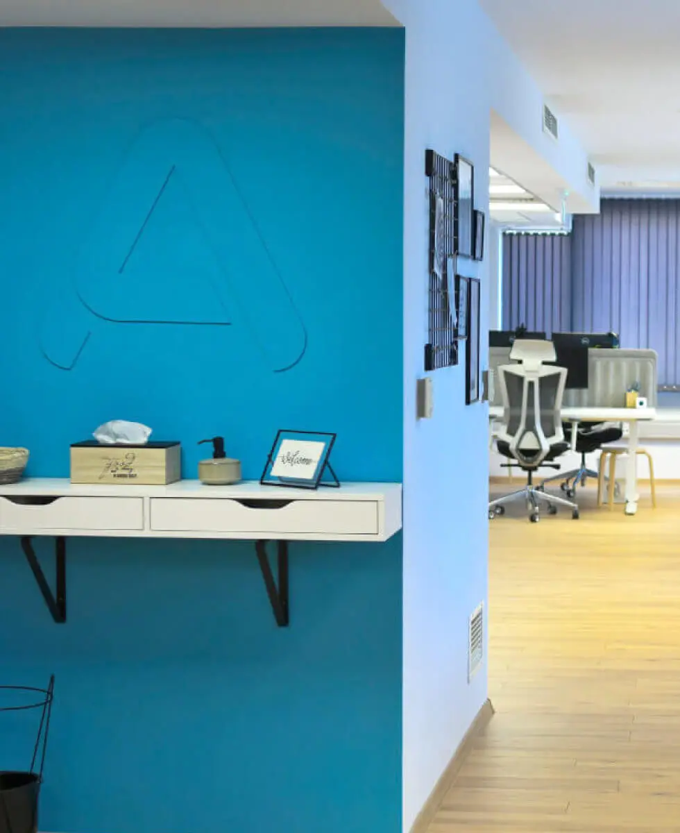 A photograph of Parachut's office with a custom 3D logo on the wall.