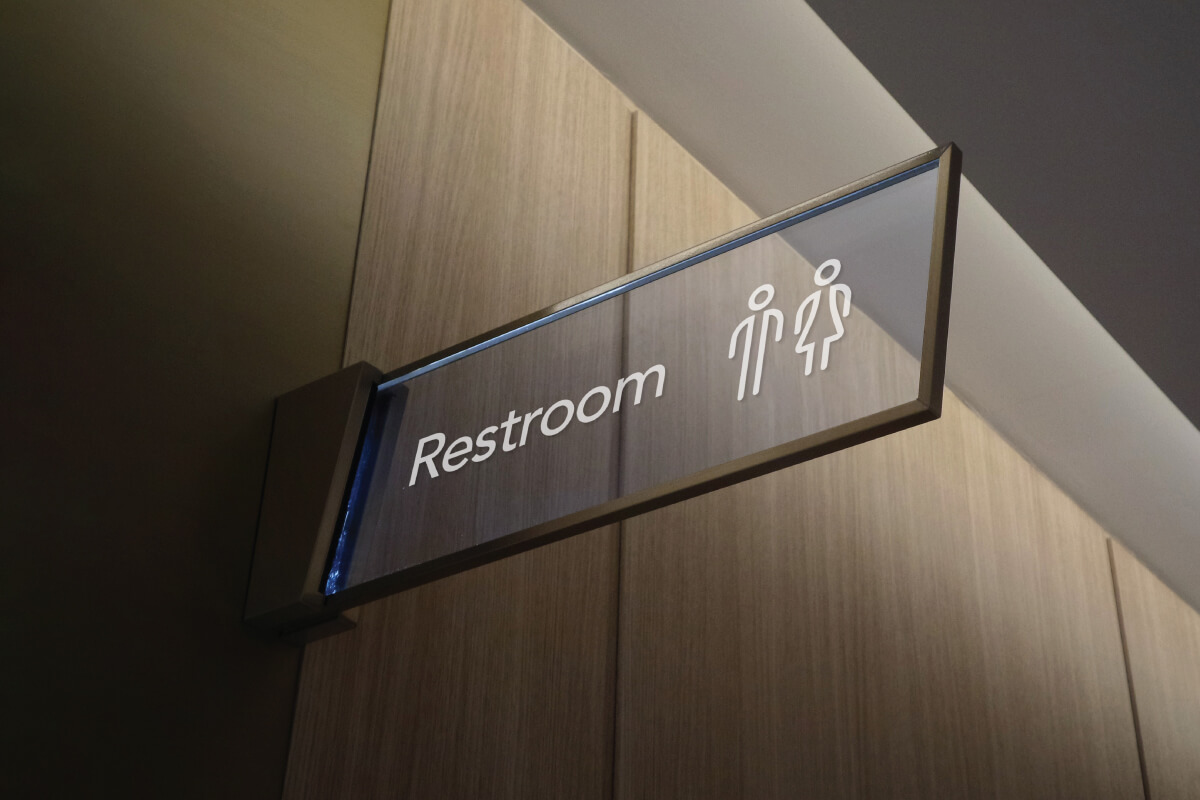 Illuminated indoor restroom sign.