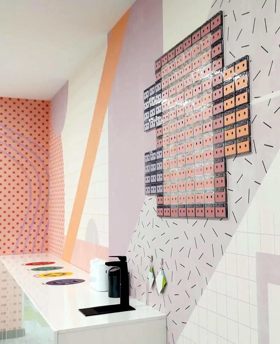 A custom wallpaper with 3D decoration made from cassette tapes we designed and installed for one of the printing zones in the VMware offices.
