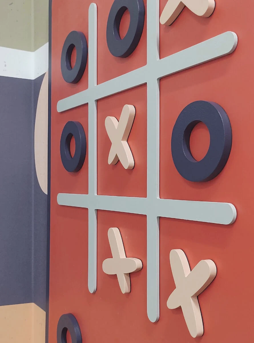 Custom magnetic tic tac toe game installed on a wall.
