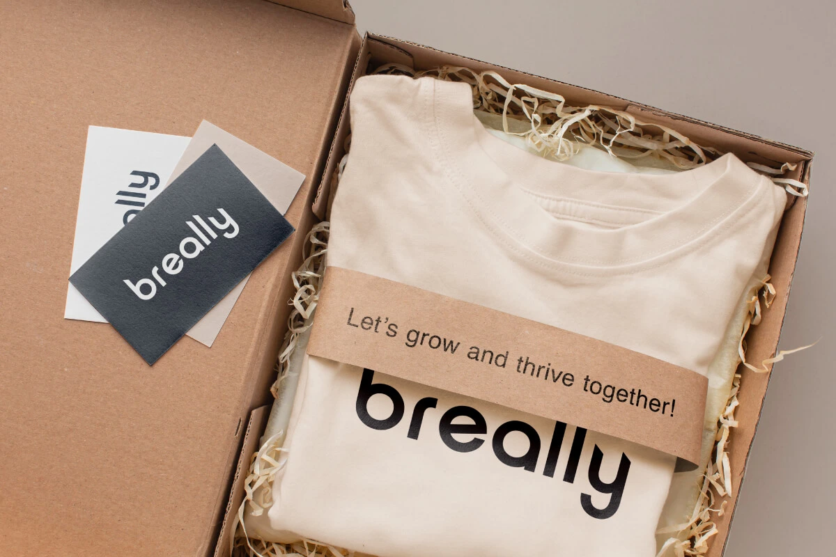 Branded t-shirt and stickers with custom logo print for employer branding.