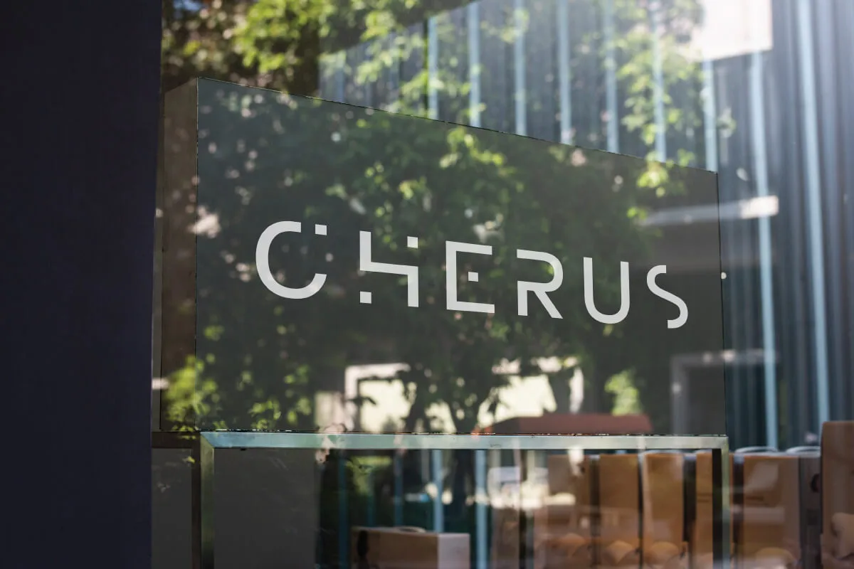 Illuminated sign behind a window shop.
